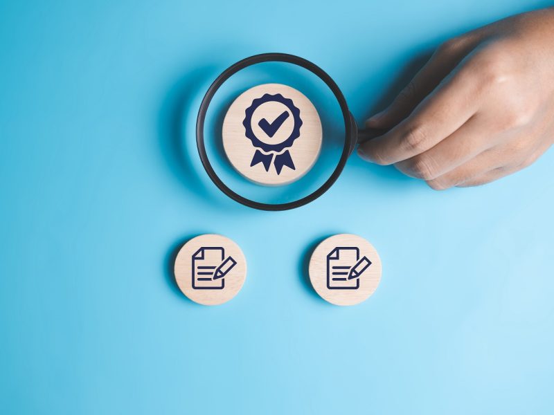 ISO smart globe with check mark guarantee icons on wooden cube and copy space, Certification and standardization, International Organization for Standardization ISO and quality control certification